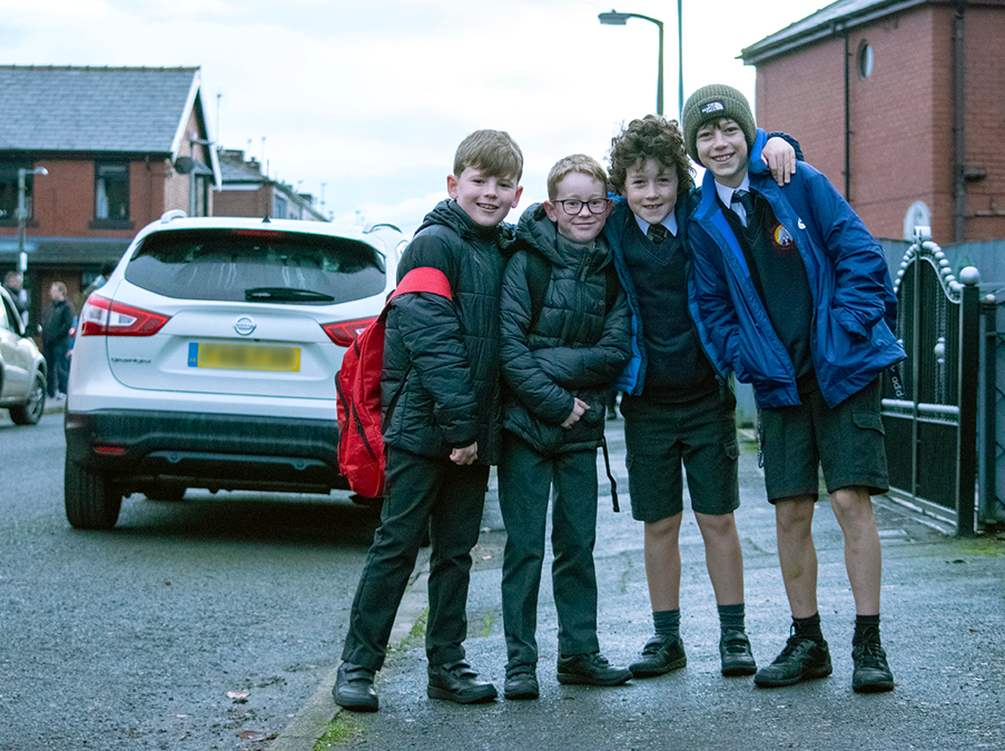 Four pupils stood on a School Street